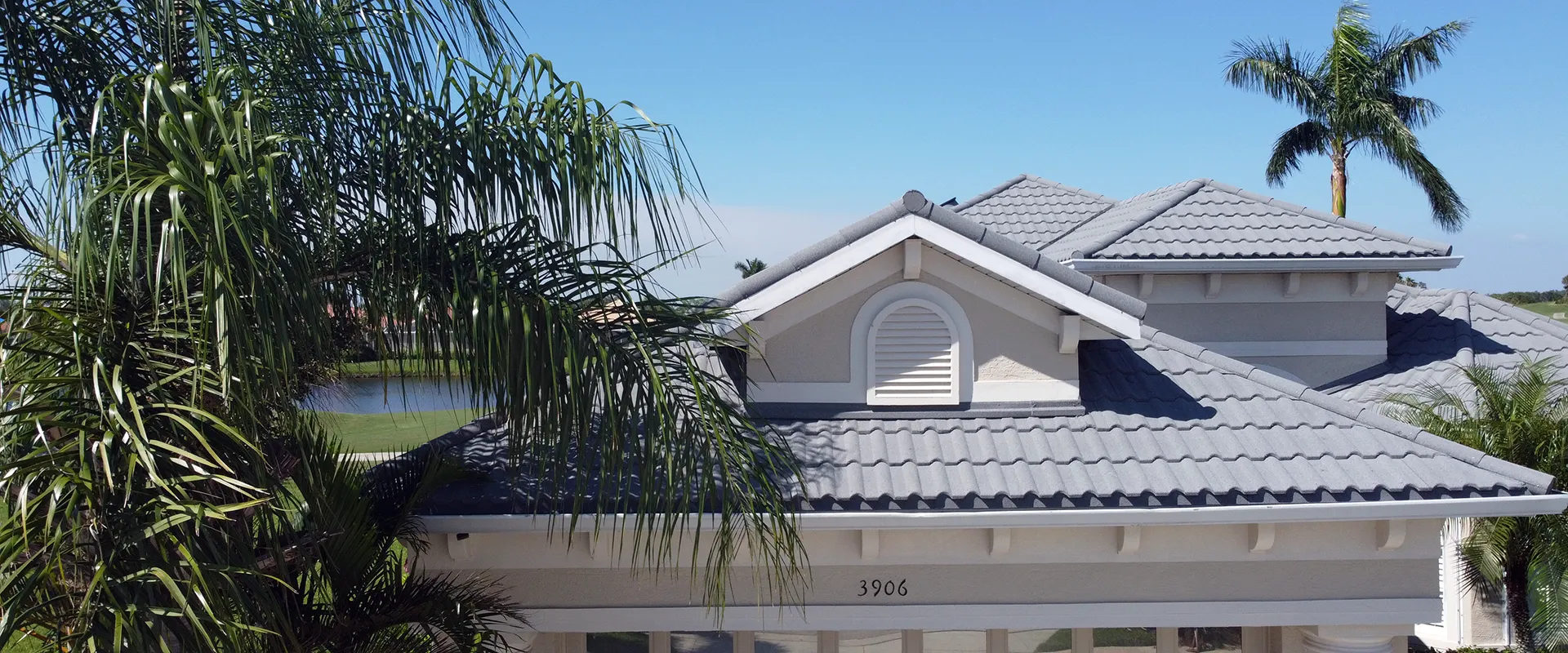 A stack of Tefute USA stone-coated steel roofing tiles in a Silver Grey Roman II profile.